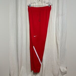Red Nike dri-fit sweatpants with ankle zippers